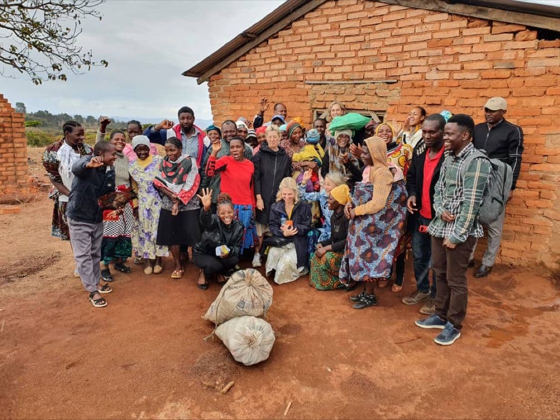Community members and partners with Nicolaus Novatus Mukasa after a field session
