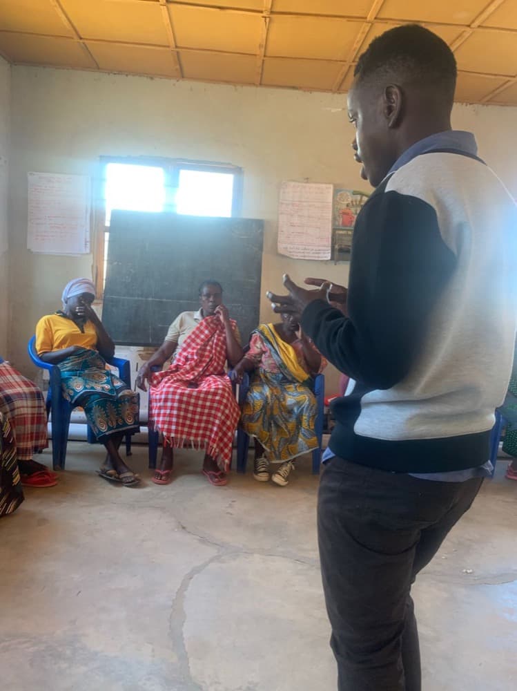 Nicolaus Novatus Mukasa facilitating a VSLA training session in Lugalo, Kilolo District
